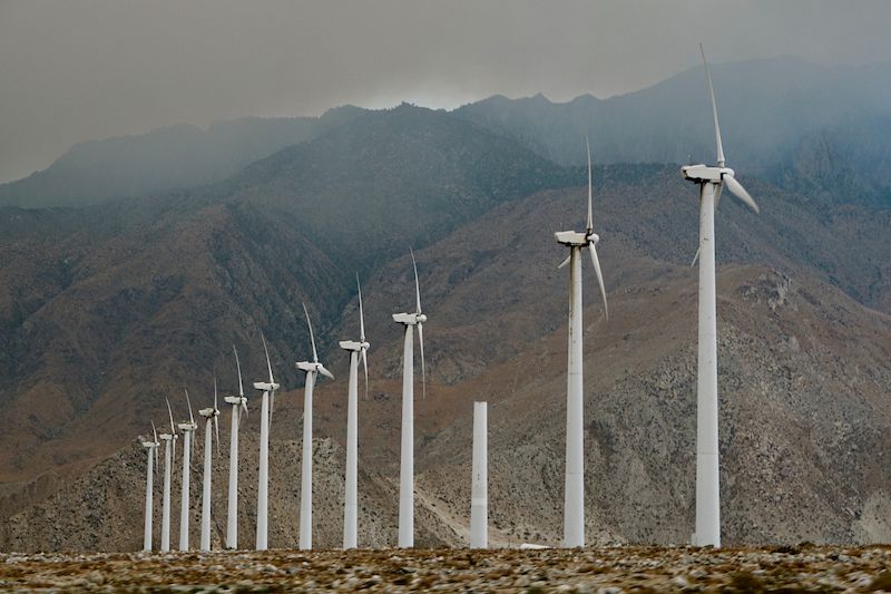 Wind turbines in front of mountains.